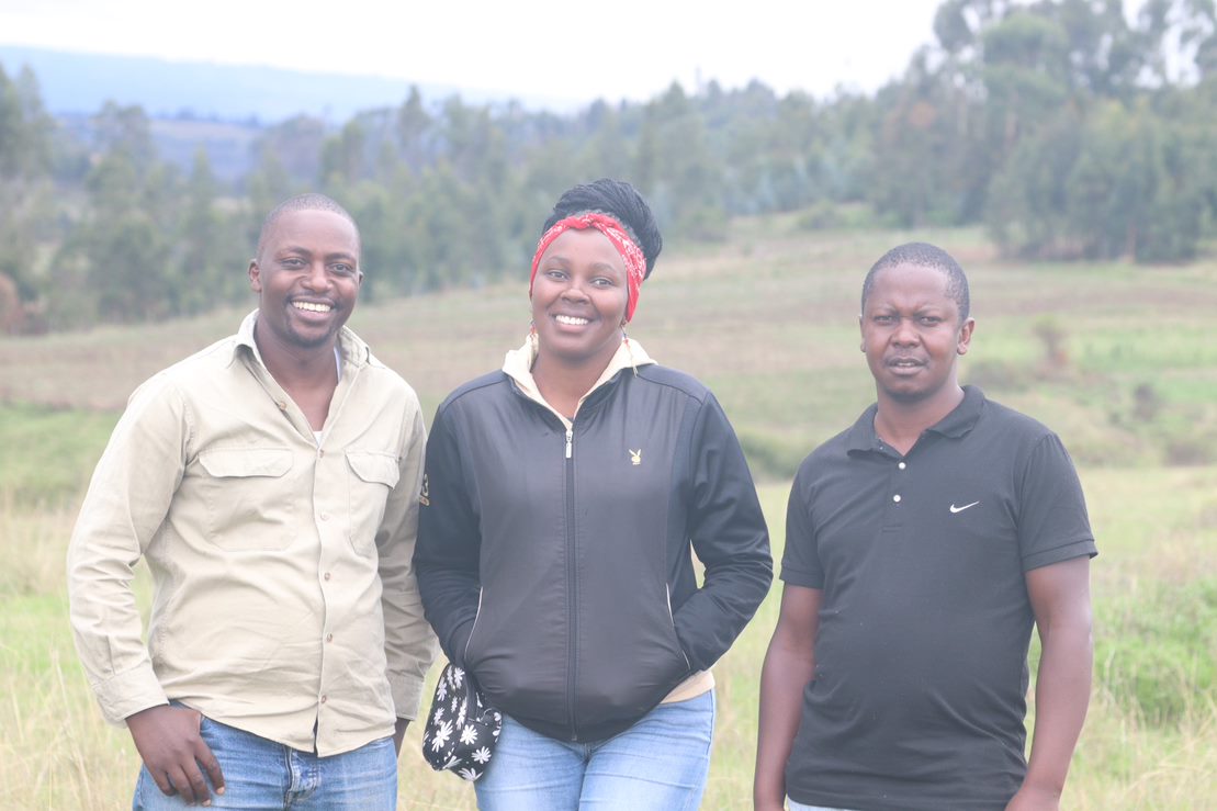 Team of conservationists standing in the grasslands
